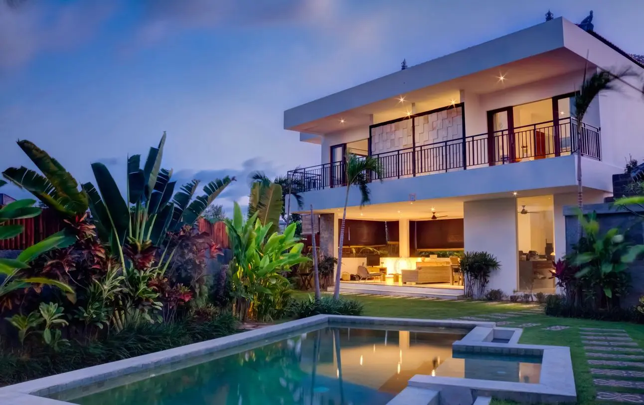 Modern house with pool at twilight.